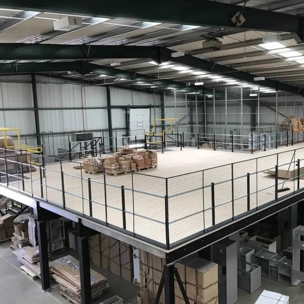 Large Mezzanine floor installation for storage use with protective railing and safety cages inside a warehouse in Shropshire